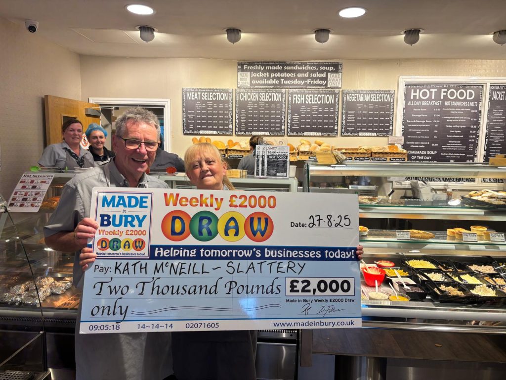 Kath McNeill, Slattery Sales Assistant, celebrating winning £2,000 in the Made In Bury Weekly Draw