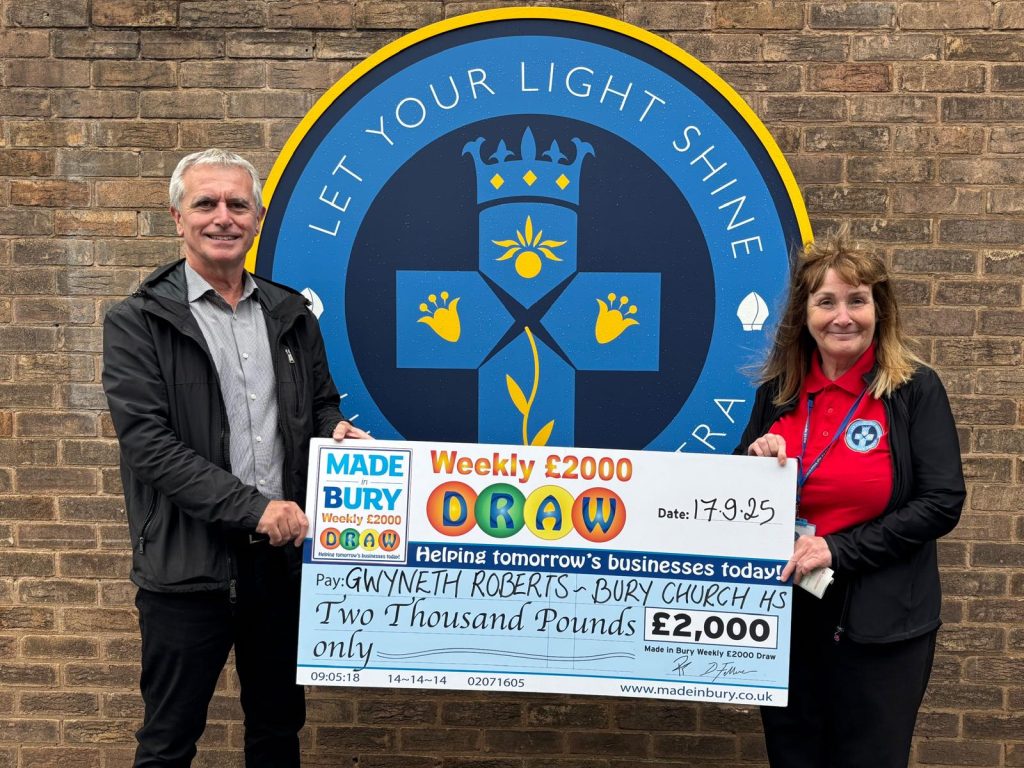 Double winner Gwyneth Roberts holding her Made in Bury Weekly £2,000 Draw cheque.